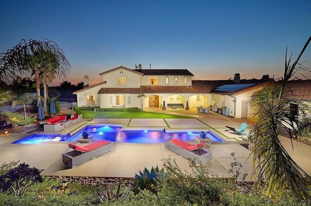 swimming pool with an in-ground hot tub and a patio area
