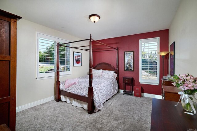 bedroom with carpet flooring and baseboards