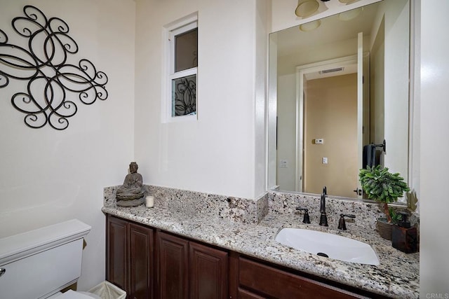 bathroom with toilet and vanity