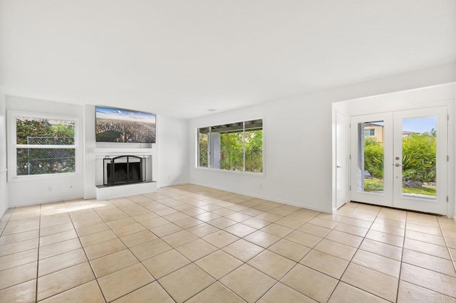 2348 Watson Way, Vista, CA 92081 - unfurnished living room featuring light tile patterned floors, a fireplace with raised hearth, baseboards, and french doors