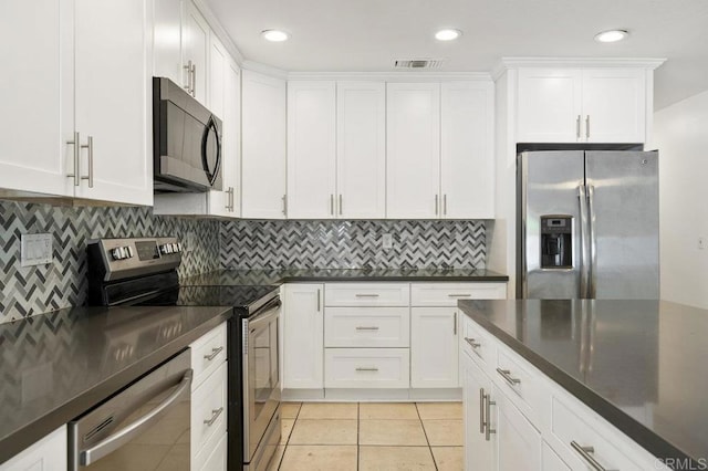2348 Watson Way, Vista, CA 92081 - kitchen featuring appliances with stainless steel finishes, dark countertops, white cabinetry, tasteful backsplash, and recessed lighting