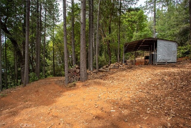 10647 Forbestown Rd, Challenge, CA 95925 - view of yard featuring a carport and a wooded view
