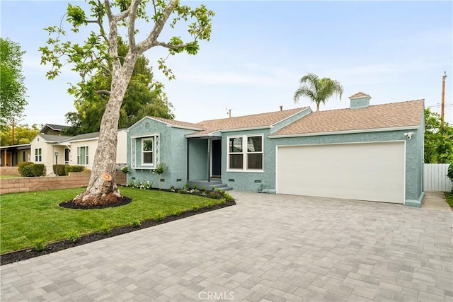 ranch-style home with stucco siding, decorative driveway, and a garage