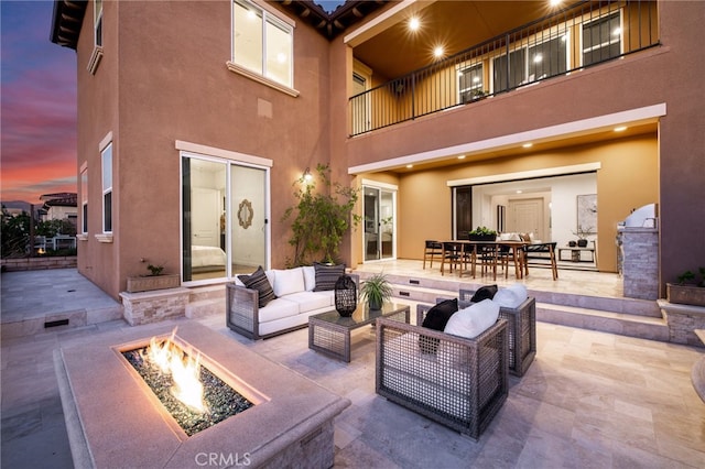 28 Dogwood, Lake Forest, CA 92630 - patio terrace at dusk with an outdoor living space with a fire pit, a balcony, and outdoor dining space