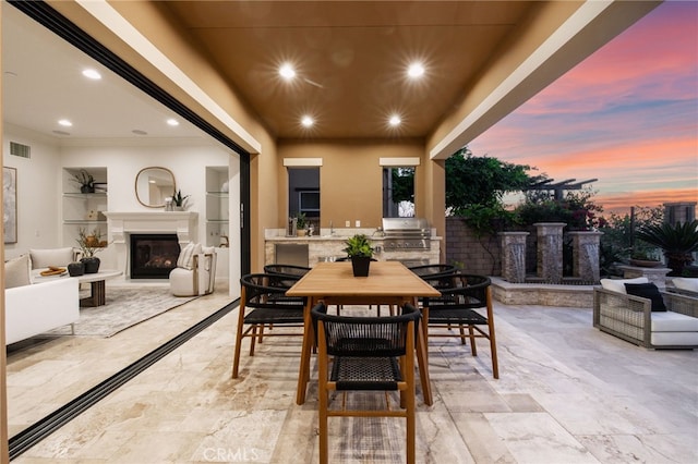 28 Dogwood, Lake Forest, CA 92630 - patio terrace at dusk with an outdoor fireplace, area for grilling, and outdoor dining area