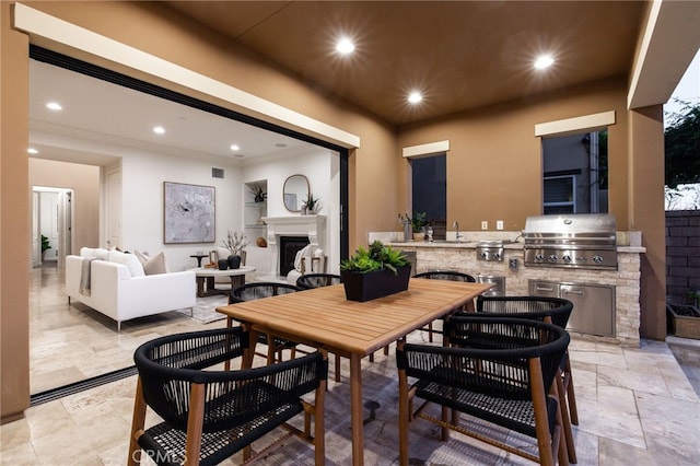 28 Dogwood, Lake Forest, CA 92630 - dining room with exterior fireplace, ornamental molding, recessed lighting, and stone tile flooring
