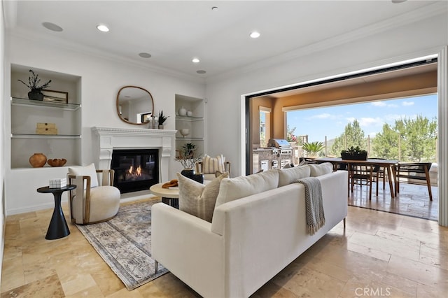 28 Dogwood, Lake Forest, CA 92630 - living area featuring built in features, crown molding, a glass covered fireplace, recessed lighting, and stone tile floors