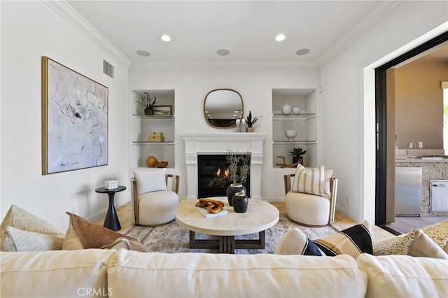 28 Dogwood, Lake Forest, CA 92630 - living room featuring built in features, wood finished floors, ornamental molding, a glass covered fireplace, and baseboards