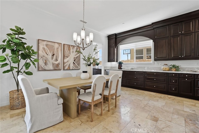 28 Dogwood, Lake Forest, CA 92630 - dining area featuring a chandelier and stone tile floors