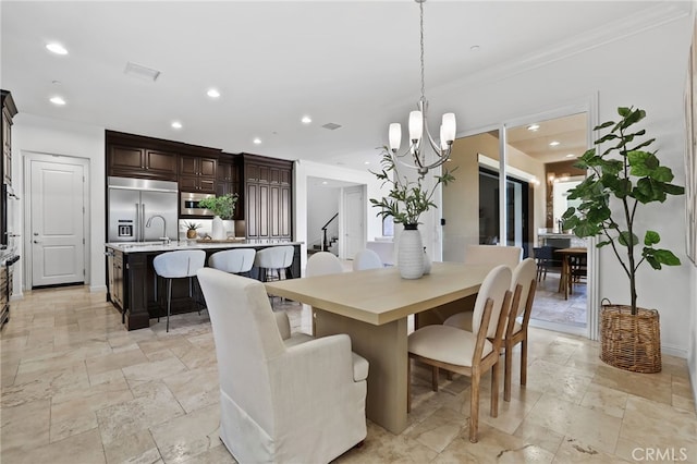 28 Dogwood, Lake Forest, CA 92630 - dining space with a chandelier, crown molding, recessed lighting, and stone tile flooring