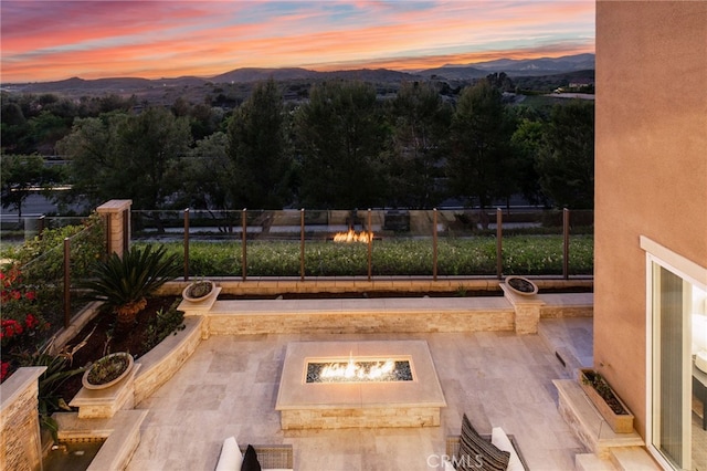28 Dogwood, Lake Forest, CA 92630 - yard at dusk with an outdoor fire pit, a mountain view, and fence