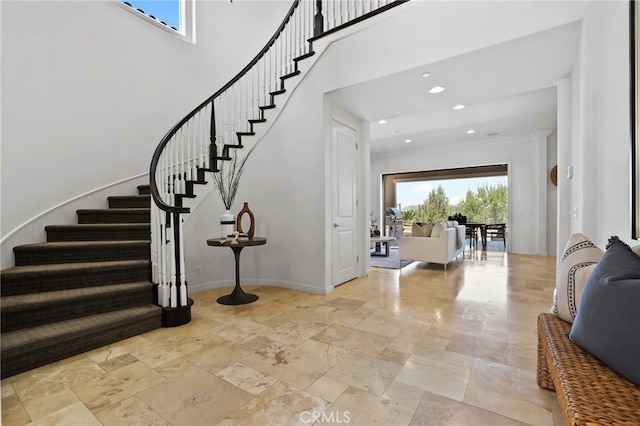 28 Dogwood, Lake Forest, CA 92630 - staircase with stone tile floors, baseboards, recessed lighting, and a towering ceiling