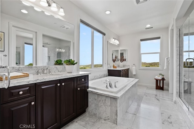 28 Dogwood, Lake Forest, CA 92630 - bathroom with plenty of natural light, a stall shower, a bath, marble tiled floors, and recessed lighting