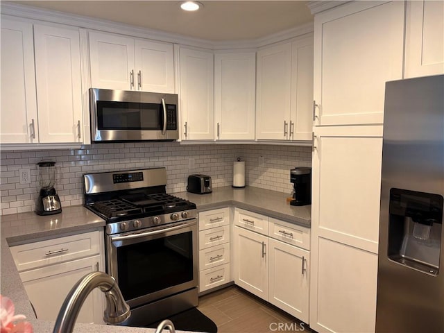 3329 E Metcalf Cir Unit B, Orange, CA 92869 - kitchen featuring stainless steel appliances, white cabinets, tasteful backsplash, and recessed lighting