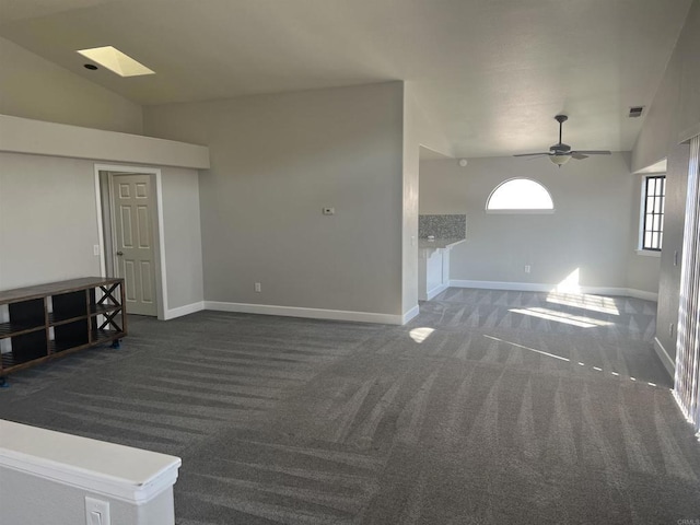 unfurnished living room with lofted ceiling, carpet, baseboards, and ceiling fan