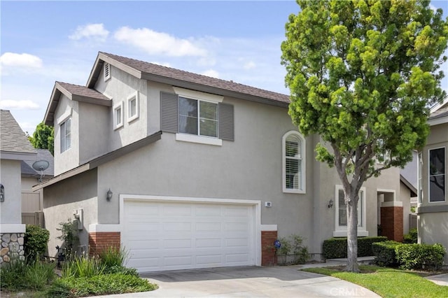 823 N Kintyre Dr, Orange, CA 92869 - townhome / multi-family property featuring a garage, brick siding, and stucco siding