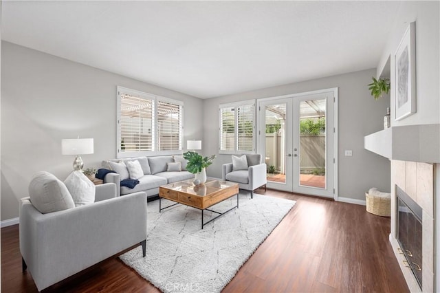 823 N Kintyre Dr, Orange, CA 92869 - living area with baseboards, dark wood-type flooring, french doors, and a tiled fireplace