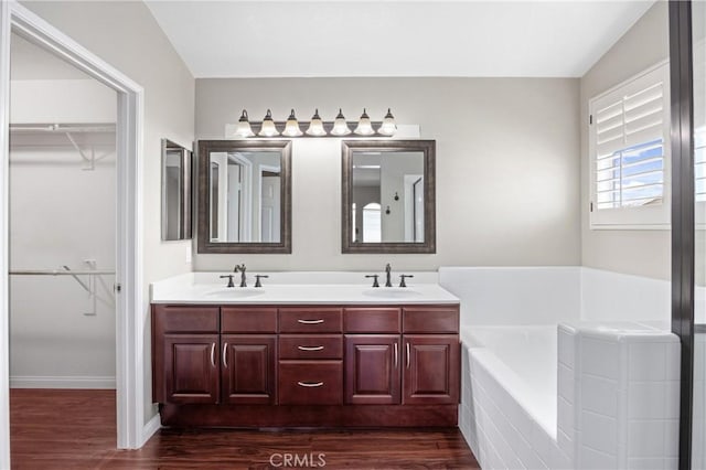 823 N Kintyre Dr, Orange, CA 92869 - full bathroom featuring wood finished floors, a garden tub, double vanity, and a walk in closet