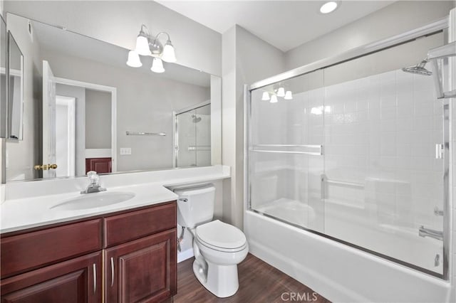 823 N Kintyre Dr, Orange, CA 92869 - bathroom featuring wood finished floors, enclosed tub / shower combo, vanity, and toilet