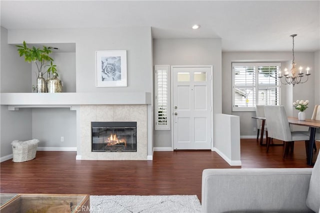 823 N Kintyre Dr, Orange, CA 92869 - living room featuring wood finished floors, a chandelier, baseboards, a tiled fireplace, and recessed lighting