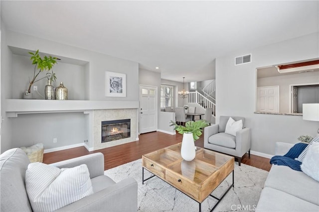 823 N Kintyre Dr, Orange, CA 92869 - living room with wood finished floors, baseboards, a chandelier, and a tile fireplace