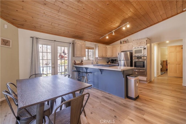 863 Ford Ln, Big Bear Lake, CA 92315 - kitchen featuring lofted ceiling, stainless steel appliances, wood ceiling, a peninsula, and a warming drawer