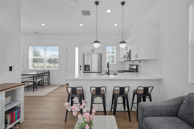 4565 S Bryant Paseo Ln, Ontario, CA 91762 - kitchen featuring stainless steel appliances, a sink, healthy amount of natural light, white cabinetry, and recessed lighting