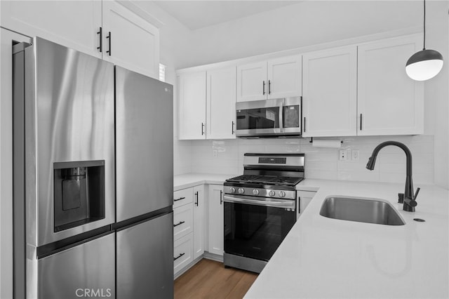 4565 S Bryant Paseo Ln, Ontario, CA 91762 - kitchen with appliances with stainless steel finishes, a sink, light countertops, white cabinets, and decorative backsplash