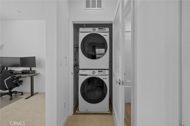 4565 S Bryant Paseo Ln, Ontario, CA 91762 - laundry area featuring stacked washer / drying machine, an office area, carpet flooring, and baseboards