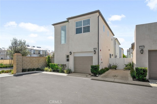 4565 S Bryant Paseo Ln, Ontario, CA 91762 - view of side of property featuring stucco siding, fence, and an attached garage