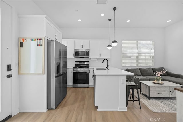 4565 S Bryant Paseo Ln, Ontario, CA 91762 - kitchen featuring stainless steel appliances, a peninsula, light wood-type flooring, a sink, and recessed lighting