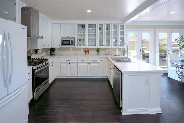 2863 W Orange Ave, Anaheim, CA 92804 - kitchen with stainless steel appliances, a sink, a peninsula, wall chimney range hood, and crown molding