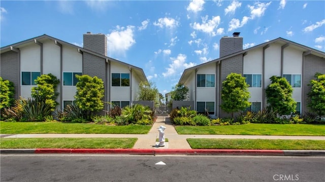 view of home's community featuring a yard