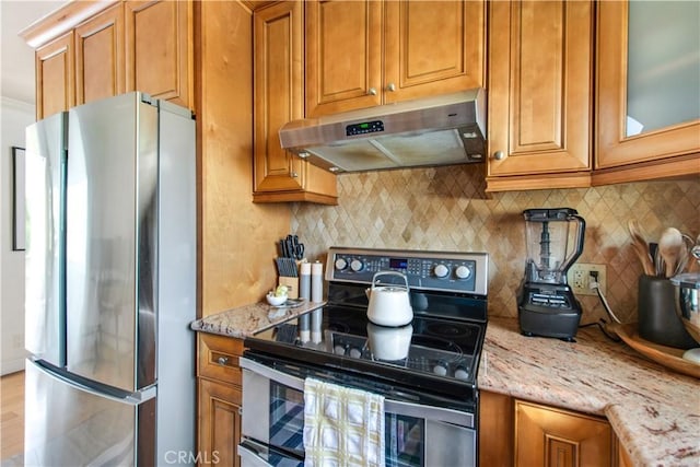 kitchen with appliances with stainless steel finishes, under cabinet range hood, and brown cabinetry