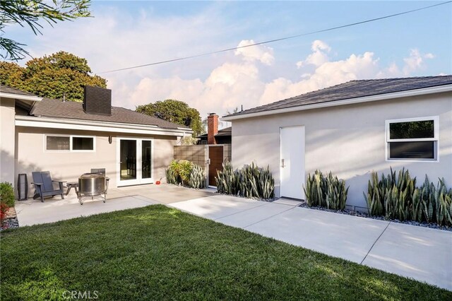 3231 Marber Ave, Long Beach, CA 90808 - rear view of property featuring stucco siding, a patio, a chimney, and a shingled roof