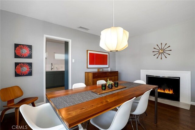 3231 Marber Ave, Long Beach, CA 90808 - dining area featuring wood finished floors and a brick fireplace