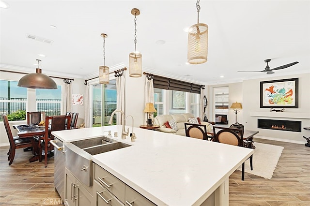 2521 Chad Zeller, Corona, CA 92882 - kitchen with ornamental molding, open floor plan, light wood-style floors, a sink, and recessed lighting