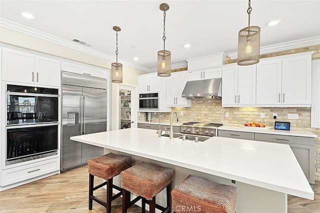 2521 Chad Zeller, Corona, CA 92882 - kitchen with built in refrigerator, under cabinet range hood, a sink, decorative backsplash, and recessed lighting