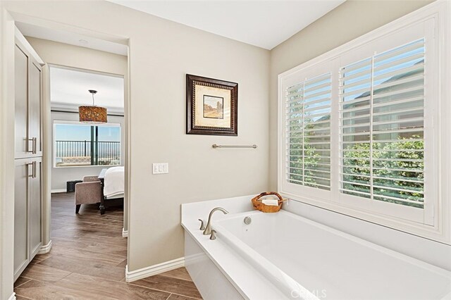 2521 Chad Zeller, Corona, CA 92882 - bathroom featuring a bath, wood finished floors, baseboards, and ensuite bath
