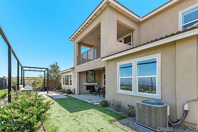 2521 Chad Zeller, Corona, CA 92882 - back of property with cooling unit, stucco siding, a balcony, and a patio
