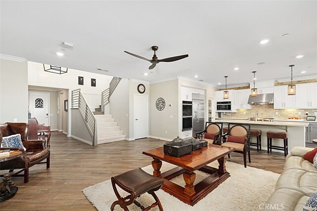 2521 Chad Zeller, Corona, CA 92882 - living area featuring a ceiling fan, crown molding, baseboards, recessed lighting, and wood finished floors