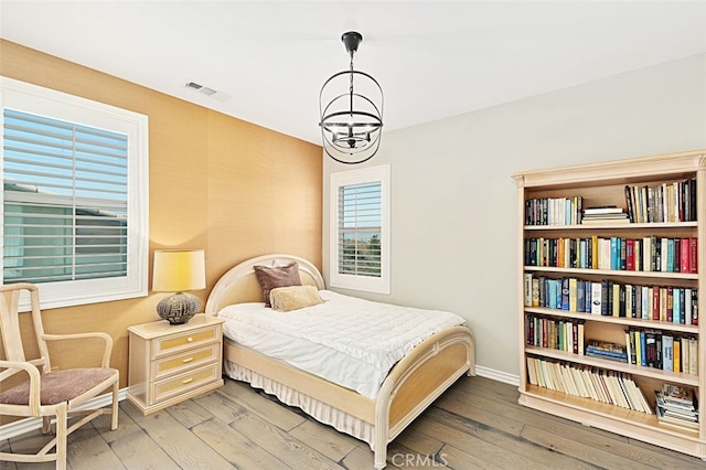 2521 Chad Zeller, Corona, CA 92882 - bedroom with baseboards, hardwood / wood-style flooring, and a chandelier