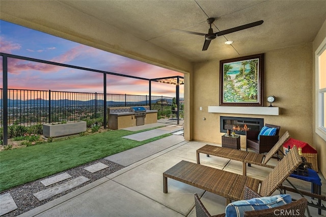 2521 Chad Zeller, Corona, CA 92882 - view of patio / terrace featuring exterior kitchen, an outdoor living space with a fireplace, a grill, and a ceiling fan