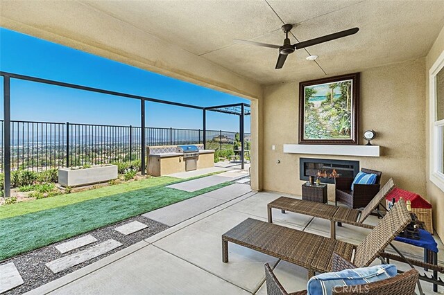 2521 Chad Zeller, Corona, CA 92882 - view of patio with an outdoor kitchen, an outdoor living space with a fireplace, area for grilling, and ceiling fan