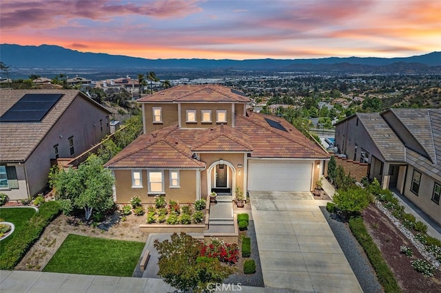 2521 Chad Zeller, Corona, CA 92882 - mediterranean / spanish-style home featuring a mountain view, concrete driveway, stucco siding, a tiled roof, and an attached garage