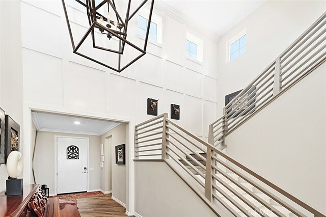 2521 Chad Zeller, Corona, CA 92882 - foyer entrance featuring a high ceiling, ornamental molding, stairs, wood finished floors, and baseboards