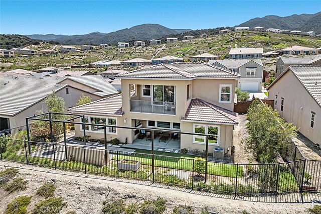2521 Chad Zeller, Corona, CA 92882 - view of front facade featuring a fenced backyard, stucco siding, a tiled roof, a mountain view, and a residential view