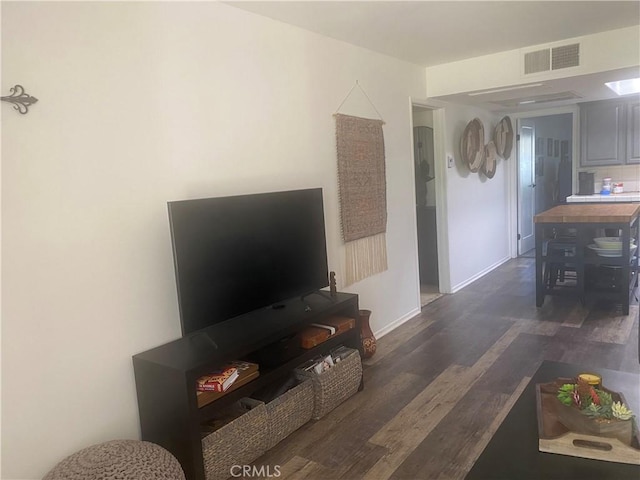 living area with wood finished floors and baseboards