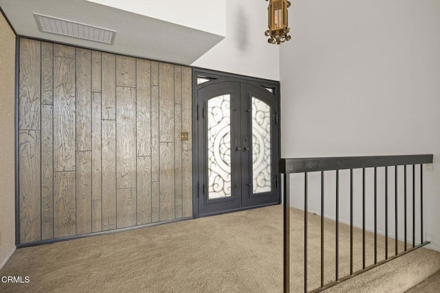 2120 Jamestown Way, Oxnard, CA 93035 - carpeted foyer entrance with wood walls and french doors
