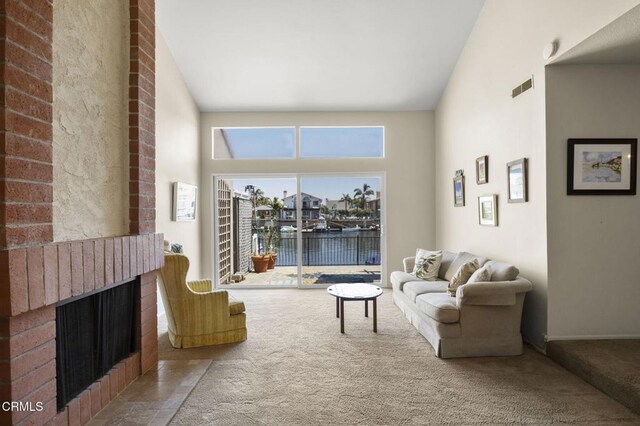 2120 Jamestown Way, Oxnard, CA 93035 - carpeted living room with a water view and a fireplace